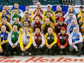 All 14 teams competing in the Tim Horton's Brier settle in for a group photo the day before the start of the event at the Scotiabank Saddledome in Calgary, Alta. on Thursday, Feb. 26, 2015. The Brier runs Feb. 28 to March 8. Lyle Aspinall/Calgary Sun/QMI Agency