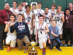 The STSS Titans celebrate their COSSA AA junior boys basketball championship victory Friday at CSS.