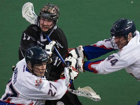 Edmonton's Robert Church battles Toronto's Glen Bryan in Friday's NLL game (David Bloom, Edmonton Sun).