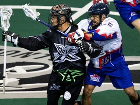 Edmonton Rush’s Jeremy Thompson (left) and Damon Edwards of the Rock battle during the first half of their NLL game on Friday night at Rexall Place in Edmonton. The visitors won in overtime. (DAVID BLOOM/QMI AGENCY)