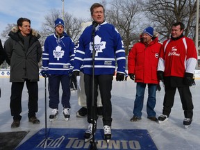 Toronto Mayor John Tory  was joined by young hockey players Toronto Maple Leafs president Brendan Shanahan, left, former Maple Leafs player Wendel Clark and current player Peter Holland along with Jason Duff  of Tim Hortons, right,  to announce the coffee chain has stepped in to help keep an additional 12 outdoor rinks open through to March Break. (Jack Boland/Toronto Sun)