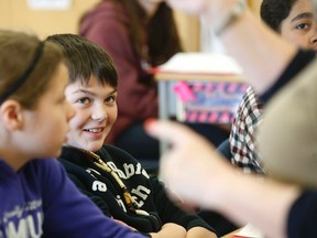 Students listen to teacher Susan Parisi in her Grade 6 class at St. Thomas Aquinas  Elementary School in Keswick. (Michael Peake/Toronto Sun)