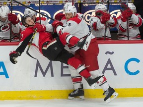 Ottawa Senators center Kyle Turris is checked by Carolina Hurricanes defenseman Tim Gleason in the third period at the Canadian Tire Centre on Jan. 17, 2015. (Marc DesRosiers/USA TODAY Sports)