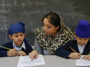Grade one teacher Guramrit Singh works with a couple of her students Khalsa Community School in Brampton.  (Dave Thomas/Toronto Sun)