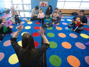 Librarian Sarah Kasprzak wiggles her fingers in the air as a group of parents and their babies take part in 2000 Words To Grow, a program that encourages parents and caregivers to use 2000 words or more an hour through reading, song and activities to promote literacy early in a child's life. CRAIG GLOVER/The London Free Press/QMI Agency
