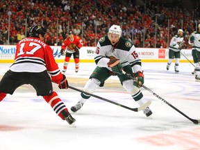 Minnesota Wild left winger Dany Heatley skates against Chicago Blackhawks defenseman Sheldon Brookbank during Game 5 of the second round of the 2014 NHLPlayoffs at the United Center on May 11, 2014. (Dennis Wierzbicki/USA TODAY Sports)