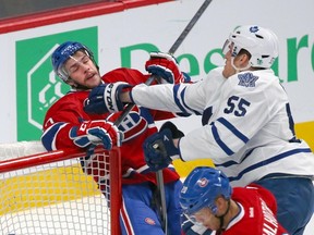 Montreal Canadiens left wing Michael Bournival (49) is checked by Toronto Maple Leafs defenseman Korbinian Holzer (55) during the third period at Bell Centre. (Jean-Yves Ahern-USA TODAY Sports)