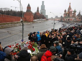 People gather at the site where Boris Nemtsov was recently murdered, with St. Basil's Cathedral and the Kremlin seen in the background, in central Moscow, February 28, 2015. (REUTERS/Sergei Karpukhin)
