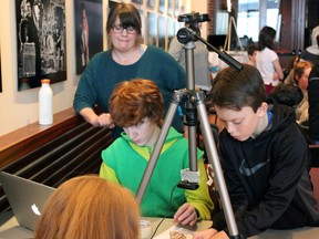 Kathy Shultz instructs Benjamin Hueglin, left, and Griffin Santry at the Youth Animation Workshop as part of the Kingston Canadian Film Festival in Kingston, Ont., on Saturday, Feb. 28, 2015. Steph Crosier/Kingston Whig-Standard/QMI Agency