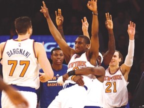 New York Knicks guard Langston Galloway celebrates with teammates after hitting a three-pointer against the Raptors during the fourth quarter at Madison Square Garden last night. (USA TODAY SPORTS)
