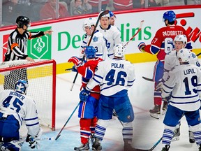 The Habs celebrate David Desharnais' third-period goal on Saturday night while an angry Jonathan Bernier gets to his knees after being interfered with by Brendan Gallagher (11). (PIERRE-PAUL POULIN, QMI Agency)