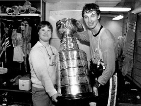 Life long friend Wayne Gretzky helps Joey Moss hold the Stanley Cup in Edmonton after winning their first  NHL Championship in May 1984 Family photo