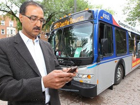 Edmonton City Councillor Amarjeet Sohi poses for a photo with his smart phone beside a bus at the University of Alberta in July 2013.  David Bloom/Edmonton Sun/QMI Agency
