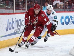 Keith Yandle #3 of the Phoenix Coyotes skates with the puck under pressure from Tomas Hertl #48 of the San Jose Sharks during the second period of the NHL game at Jobing.com Arena on April 12, 2014 in Glendale, Arizona. (Christian Petersen/Getty Images/AFP)