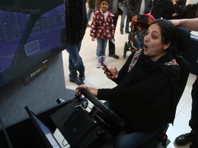 Riffat Yusaf tries -- and fails -- to safely text and drive Sunday, March 1, 2015 at the Bayshore Shopping Centre. Ottawa police and paramedics were leading people through a demonstration of a unique distracted driving simulator.
DOUG HEMPSTEAD/Ottawa Sun