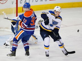 Feb 28, 2015; Edmonton, Alberta, CAN; Edmonton Oilers forward Ryan Nugent-Hopkins (93) and St. Louis Blues forward Jori Lehtera (12) follow a loose puck during the first period at Rexall Place. Mandatory Credit: Perry Nelson-USA TODAY Sports