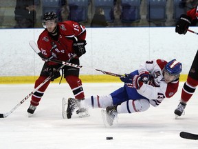 Kingston Voyageurs’ forward Joey Beaudoin gets a shot off between Stouffville Spirit players Matthew Dunlop, left, and Alex Gilmour during action in Game 3 of their Ontario Junior Hockey League first-round playoff series at the Invista Centre on Sunday. (Steph Crosier/The Whig-Standard)