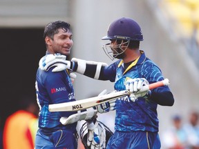 Sri Lanka’s Kumar Sangakkara (left) and Lahiru Thirimanne celebrate after beating England in their Cricket World Cup match. (REUTERS)