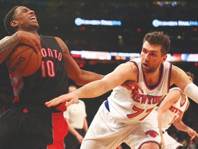 Raptors guard DeMar DeRozan grabs a loose ball in front of New York Knicks centre Andrea Bargnani on Saturday night. (USA TODAY SPORTS)