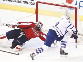 Capitals goalie Braden Holtby makes a save on Leafs winger Richard Panik during last night’s game in Washington. (USA TODAY SPORTS)