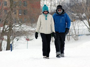 Lesley Rudy, left, and Rob Seaby out for a stroll in Molly Brant and Douglas Fluhrer Park on Sunday.  (Steph Crosier/TheWhig-Standard)