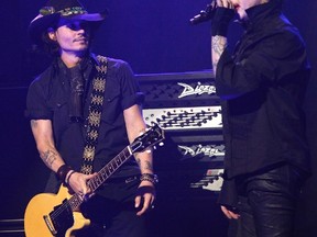 Johnny Depp, left, performs with musician Marilyn Manson at the 2012 Revolver Golden Gods Award Show at Club Nokia in Los Angeles, California April 11, 2012. (REUTERS/Mario Anzuoni)