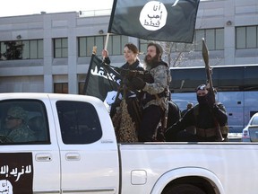 Dakota Johnson, holding a flag, plays a young woman going off to fight with the Islamic State militant group in a fake ISIS commercial on "Saturday Night Live." (Dana Edelson / NBC)