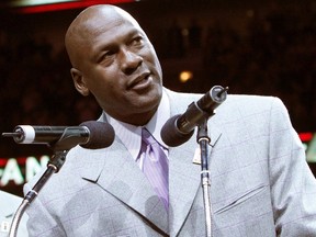 Former Bulls star Michael Jordan (R) talks to the crowd during a ceremony to honor the 20th anniversary of the Chicago Bulls' first world championship at half time of the NBA basketball game between the Utah Jazz and Chicago Bulls in Chicago, Illinois in this file photo from March 12, 2011.  (REUTERS)