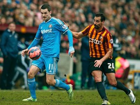 Sunderland's Adam Johnson (left) was arrested Monday, accused of having sex with a 15-year-old girl. (Phil Noble/Reuters)