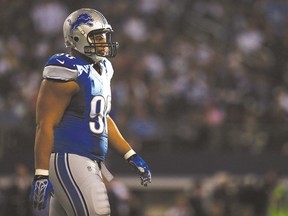 Ndamukong Suh #90 of the Detroit Lions walks towards the sideline after a possession against the Dallas Cowboys during the first half of their NFC Wild Card Playoff game at AT&T Stadium on January 4, 2015 in Arlington, Texas.  Sarah Glenn/Getty Images/AFP