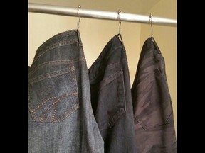 Organize your jeans and pants by hanging them on shower curtain hooks.