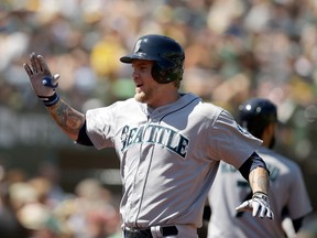 Corey Hart #27 of the Seattle Mariners reacts on his way back to the dugout after hitting a home run in the seventh inning of their game against the Oakland Athletics at O.co Coliseum on September 3, 2014 in Oakland, California. (Ezra Shaw/Getty Images/AFP)