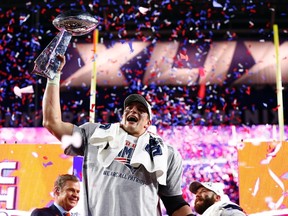 Patriots tight end Rob Gronkowski hoists the Vince Lombardi Trophy after defeating the Seahawks in Super Bowl XLIX in Phoenix on Sunday, Feb. 1, 2015. (Mark J. Rebilas/USA TODAY Sports)