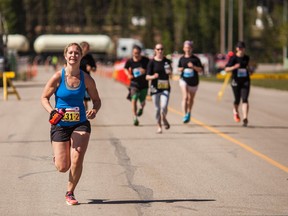 Kyla Halbert from Whitecourt, Alta., runs the final stretch before the finish line at the Fallen 4 Marathon which concluded in Whitecourt on June 8, 2014.The Fallen 4 Marathon Society formed for the purpose of starting a memorial marathon and relay in honour of the sacrifice made by the fallen officers, Constable Peter Schiemann, Constable Leo Johnston, Constable Anthony Gordon and Constable Brock Myrol on March 5, 2005. Proceeds generated from this annual event are donated to the numerous local non-profit groups and help keep the Mayerthorpe Fallen Four Memorial Society operational. Christopher King/Whitecourt Star