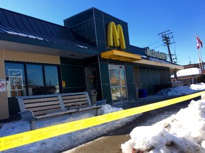 Police tape at the McDonald's at Danforth-Coxwell Aves. where two men were fatally shot on Saturday, Feb. 28, 2105. (Chris Doucette/Toronto Sun)
