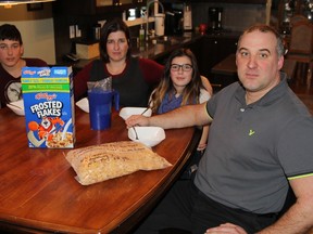 Timmins high school teacher Stephane Gaudette, right, and his wife and two children sat down to breakfast and opened a box of Kellogg?s Frosted Flakes only to find the inner bag had a message noting it was the "very last bag of Canadian cereal for the Canadian market from Kellogg?s London Ontario plant." The family members, from left, are Maxime, Lyanne, Jacynthe, and Stephane who teaches history at Ecole secondaire catholique Theriault. (RON GRECH, Timmins Daily Press)