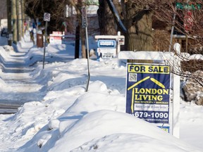 A cluster of for sale signs on Ridout St. in London, where housing prices are attractive, relative to other cities. (CRAIG GLOVER, The London Free Press)