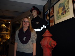 Amanda VandenWyngaert, curator of the Aylmer-Malahide Museum and Archives, stands near artifacts included in a new exhibit devoted to a massive Aylmer fire of 50 years ago this winter. (Ben Forrest, Times-Journal(