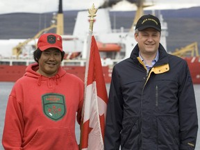Canada's Prime Minister Stephen Harper (R) pose for a photograph with an Arctic Ranger in the Arctic port of Nanisivik, Nunavut, August 10, 2007.