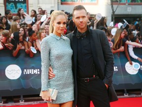 Actress Laura Vandervoort and fiance Oliver Trevena pose on the red carpet at the MuchMusic Video Awards (MMVA) in Toronto, June 15, 2014. REUTERS/Mark Blinch