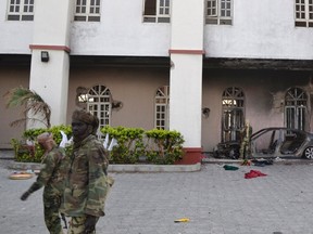 Chadian soldiers walk in front of a building that Boko Haram insurgents used as their base before being driven out by the Chadian military in Dikwa March 2, 2015. Chadian troops have driven Boko Haram militants out of the northeast Nigerian town of Dikwa, losing one soldier in the battle, an army spokesman said on Monday. Picture taken March 2, 2015. REUTERS/Madjiasra Nako