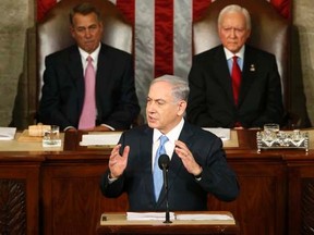 Israeli Prime Minister Benjamin Netanyahu (C) addresses a joint meeting of Congress in the House Chamber on Capitol Hill in Washington, March 3, 2015. U.S. Speaker of the House John Boehner (L) (R-OH) and President pro tempore of the U.S. Senate Orrin Hatch (R-UT) listen to Netanyahu. REUTERS/Jonathan Ernst