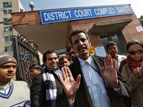 Manohar Lal Sharma, centre, lawyer of one of the accused, Mukesh Singh, speaks with the media outside a district court in New Delhi in this Jan. 10, 2013 file photo. (REUTERS/Adnan Abidi)