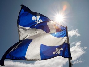 A Quebec flag flaps in the sky on the Plains of Abraham in Quebec City, in this September 13, 2009, file photo.  REUTERS/Mathieu Belanger/Files