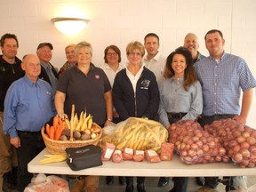The produce here is just part of what was donated by Chatham-Kent agricultural community to area food banks on Food Freedom Day. From left, Joe Grootenboer, Louie Roesch, Jacques Tetreault, Joe Vanek, Rhonda Dickson, Stephanie Watkinson, Brenda LeClair, Bob Daniels, Mary Anne Udvari, Mike Buis and Adam Stallaert.