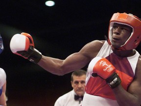 U.S. boxer Jermain Taylor (R) lands a right hand punch on Canadian boxer Scott MacIntosh in the second round of their 71 KG bout September 23, 2000 at the Sydney Olympics. (REUTERS)