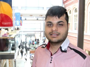 Queen's University commerce student Ahsen Basit has developed a smart phone app that connects businesses with local customers and provides rewards points and special offers. (Michael Lea/The Whig-Standard)