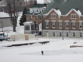 A man can be seen watering the outdoor skating rink behind Royal Military College during the few sunny breaks and the slightly warmer temperature seen in Kingston. In its spring outlook, The Weather Network said the cold weather that started in January and reached a peak in February locally is likely to continue through March and April with below normal temperatures in Ontario. (Julia McKay/The Whig-Standard)