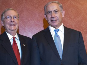 Senate Majority Leader Mitch McConnell (L), R-KY, and Senate Minority Leader Harry Reid (R), D-NV, pose with Israel's Prime Minister Benjamin Netanyahu ahead of a meeting at the US Capitol on March 3, 2015 in Washington, DC. (AFP/MANDEL NGAN)