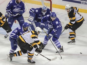 Kingston Frontenacs’ Lawson Crouse battles for the puck against Mississauga Steelheads Bryson Cianfrone (19) and Sean Day (4) during Ontario Hockey League action at the Rogers K-Rock Centre on Oct. 10. (Whig-Standard file photo)